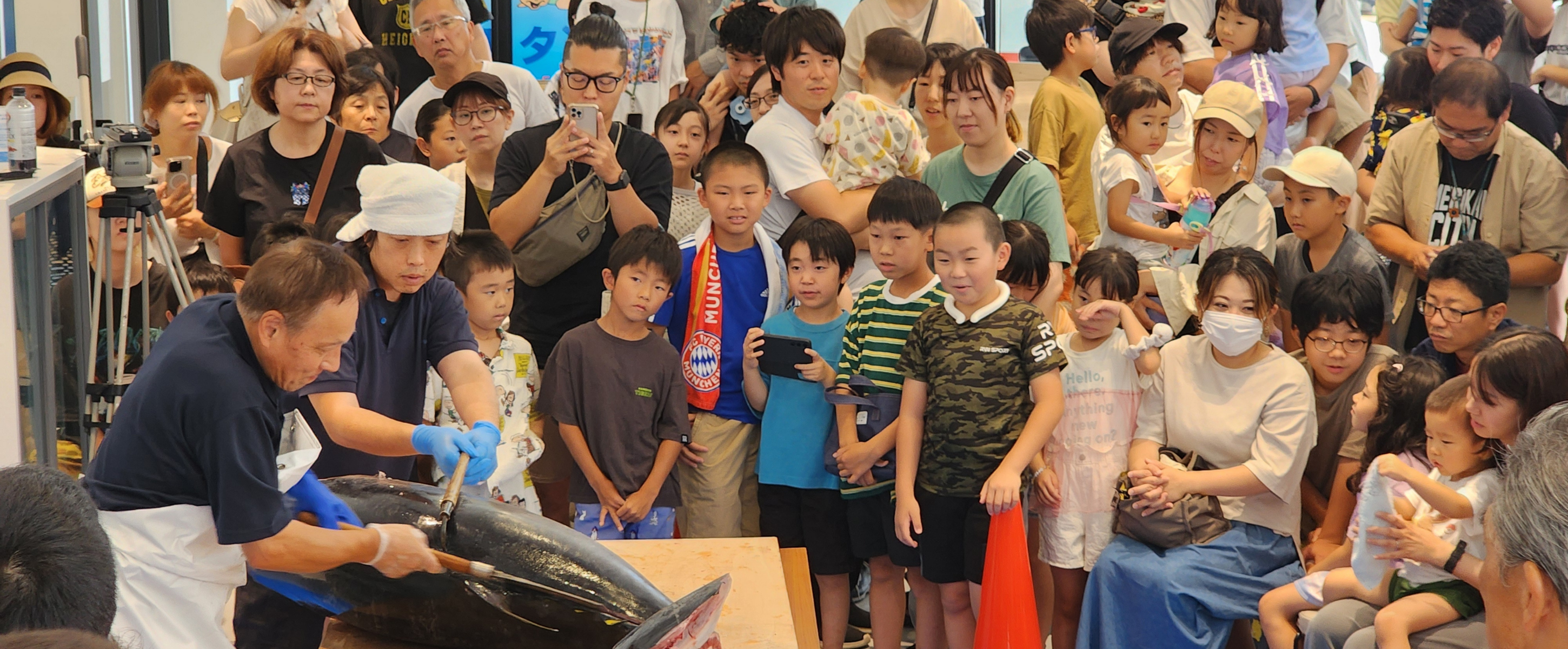 魚の解体ショーを見つめる子どもたち