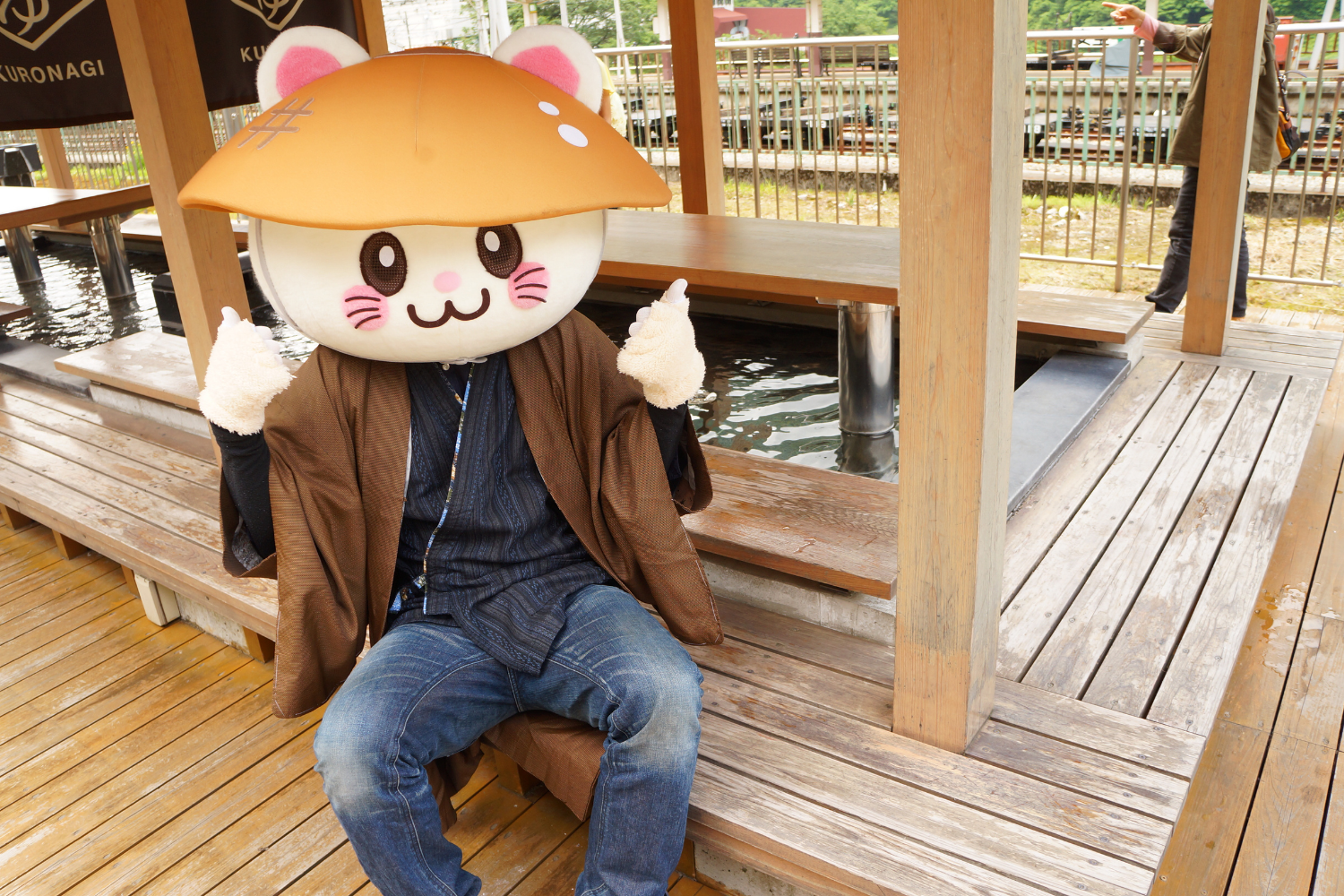 デッキに座って親指を立てるばいにゃこさん